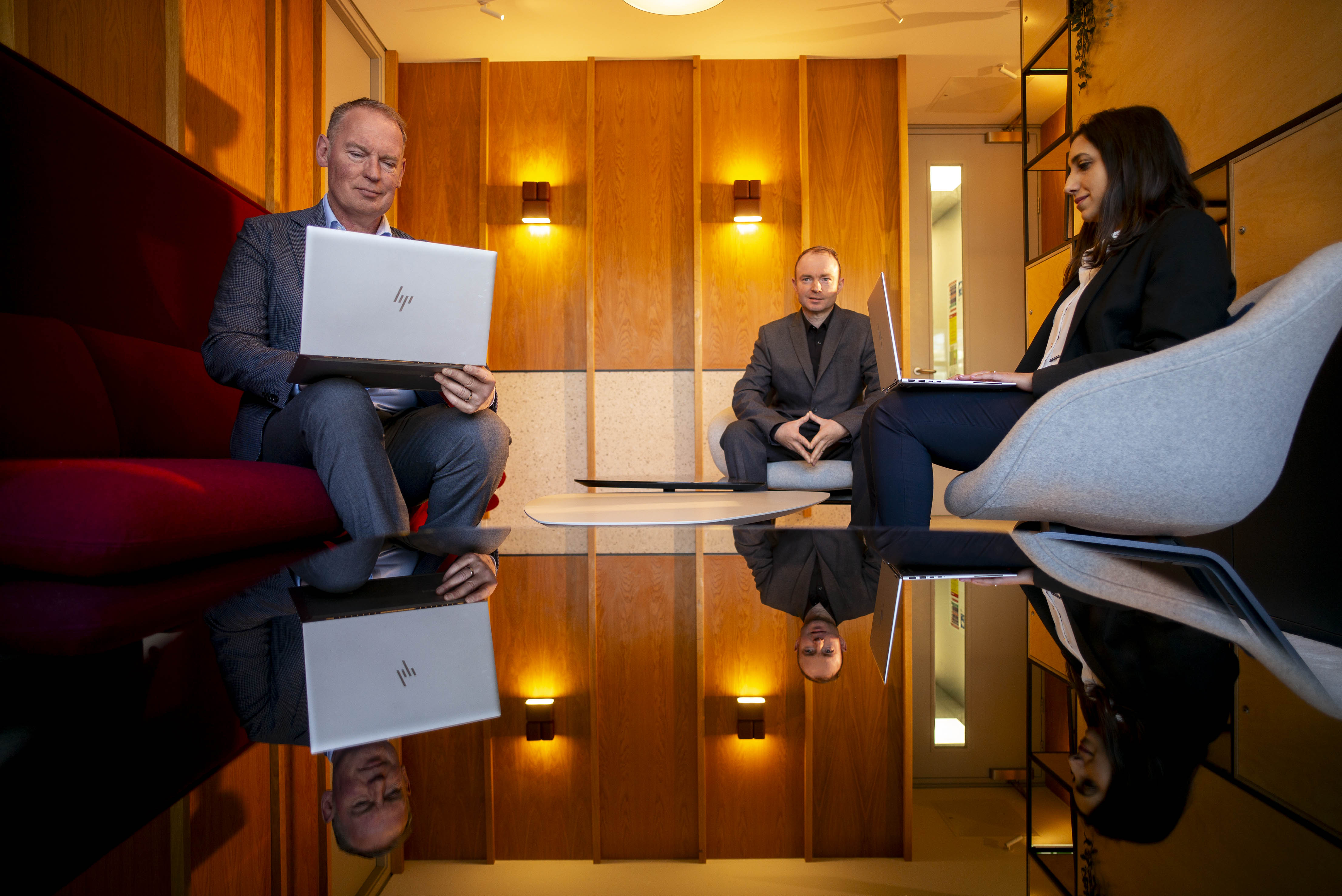 group of colleagues looking at a laptop