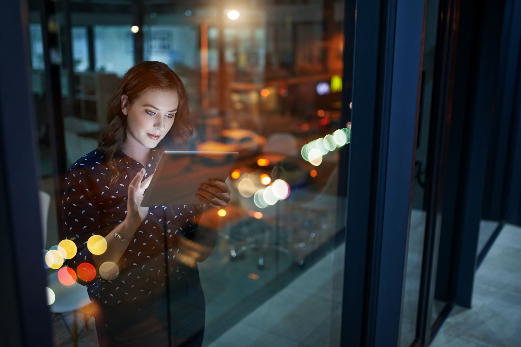 woman looking at a tablet in office 